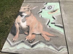 dog drawn in chalk on the sidewalk